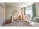 Cozy Bedroom with a crib, rocking chair, and sweet décor creating a warm and inviting space for baby at 3389 La Cura Ave # Lot 43, Las Vegas, NV 89141