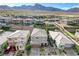 Aerial view of a residential neighborhood with mountain views and well-maintained homes at 361 Cooper Hawk Ct, Las Vegas, NV 89138
