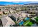 Aerial view of a home with a backyard featuring a pool, manicured lawn, and outdoor seating at 361 Cooper Hawk Ct, Las Vegas, NV 89138