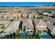 Overhead view of neighborhood with pools and desert landscape, with mountains in background at 361 Cooper Hawk Ct, Las Vegas, NV 89138