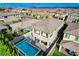 Aerial view of a backyard with a pool, covered seating area, and manicured landscaping at 361 Cooper Hawk Ct, Las Vegas, NV 89138