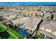 Aerial view of a backyard with a pool, covered seating area, landscaping and mountain views at 361 Cooper Hawk Ct, Las Vegas, NV 89138
