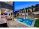 Luxurious backyard with a large pool, patio area, outdoor kitchen, and lush landscaping at 361 Cooper Hawk Ct, Las Vegas, NV 89138