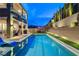 Luxurious backyard with a large pool, patio area, outdoor kitchen, and lush landscaping at 361 Cooper Hawk Ct, Las Vegas, NV 89138