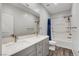 Bathroom featuring a double vanity with a quartz countertop, framed mirror, and shower/tub at 361 Cooper Hawk Ct, Las Vegas, NV 89138