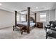 Spacious bedroom featuring a four-poster bed, tray ceiling, and neutral color palette at 361 Cooper Hawk Ct, Las Vegas, NV 89138