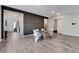 Bright dining room features a modern table, statement wall, and stylish gray wood flooring at 361 Cooper Hawk Ct, Las Vegas, NV 89138