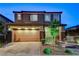 Two-story home with a well-manicured front yard, brick accents, and two-car garage at 361 Cooper Hawk Ct, Las Vegas, NV 89138