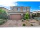 Charming two-story home with a well-manicured front yard and a two-car garage at 361 Cooper Hawk Ct, Las Vegas, NV 89138