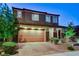 Charming two-story home showcasing a well-manicured front yard and a two-car garage with brick-paved driveway at 361 Cooper Hawk Ct, Las Vegas, NV 89138