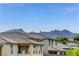 A view of the home's roof with a mountain range as a backdrop beneath a brilliant blue sky at 361 Cooper Hawk Ct, Las Vegas, NV 89138