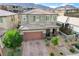 Charming two-story home with a two-car garage, well-manicured front yard, and neutral color scheme at 361 Cooper Hawk Ct, Las Vegas, NV 89138