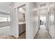 Hallway provides access to a bathroom and office, with natural light illuminating the hardwood flooring at 361 Cooper Hawk Ct, Las Vegas, NV 89138