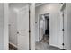 Hallway with modern doors leading to a bathroom and bedroom, showcasing the home's layout at 361 Cooper Hawk Ct, Las Vegas, NV 89138