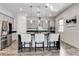 Modern kitchen features stainless steel appliances, granite countertops, and stylish pendant lighting at 361 Cooper Hawk Ct, Las Vegas, NV 89138