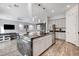Open-concept kitchen with a large island, stainless steel appliances, and adjacent living and dining areas at 361 Cooper Hawk Ct, Las Vegas, NV 89138