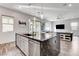 Open kitchen island with barstool seating, modern fixtures, and views of the living area at 361 Cooper Hawk Ct, Las Vegas, NV 89138