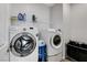 Well-equipped laundry room features a Samsung washer and dryer with storage and shelving for convenience at 361 Cooper Hawk Ct, Las Vegas, NV 89138