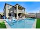 Back exterior view of a home with a private pool, patio, and outdoor seating area at 361 Cooper Hawk Ct, Las Vegas, NV 89138