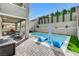 Inviting backyard pool featuring lounge chairs, an umbrella, a built-in grill, and lush landscaping at 361 Cooper Hawk Ct, Las Vegas, NV 89138