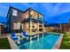 Inviting backyard pool area with modern lounge chairs, outdoor kitchen and second story balcony at 361 Cooper Hawk Ct, Las Vegas, NV 89138