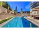 Backyard pool with landscaped terraced wall providing privacy and elegance with lawn and patio areas at 361 Cooper Hawk Ct, Las Vegas, NV 89138