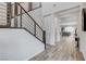 Modern staircase with sleek railings and hardwood floors leading to an open-concept living space at 361 Cooper Hawk Ct, Las Vegas, NV 89138