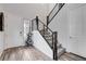 Modern staircase with carpet on steps with metal railing, adjacent to the front entrance and an adjacent room at 361 Cooper Hawk Ct, Las Vegas, NV 89138