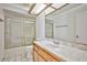 Bathroom with wood vanity, tile counters, and shower with glass doors at 4083 Nook Way # D, Las Vegas, NV 89103
