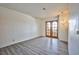 Bedroom with wood-look patio doors, light fixture, and gray wood flooring at 4083 Nook Way # D, Las Vegas, NV 89103