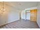 Bedroom with wood flooring, light fixture, and closet with sliding wood doors at 4083 Nook Way # D, Las Vegas, NV 89103