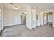 Bright living room with wood flooring, white walls, modern chandelier, and stainless steel refrigerator at 4083 Nook Way # D, Las Vegas, NV 89103