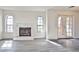Cozy living room featuring wood-look flooring, a stone fireplace, and ample natural light at 4083 Nook Way # D, Las Vegas, NV 89103