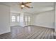 Bright living room featuring wood-look floors, white walls, and a ceiling fan at 4083 Nook Way # D, Las Vegas, NV 89103