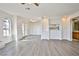 Spacious living area with wood-look floors, featuring an open layout to the kitchen and bathroom at 4083 Nook Way # D, Las Vegas, NV 89103