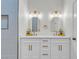 Bathroom featuring double sinks with quartz counters, modern fixtures, and vertical tile shower at 4800 Grey Wolf Ln # 202, Las Vegas, NV 89149