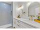 Bathroom featuring double sinks, marble countertops and a sleek glass shower at 4800 Grey Wolf Ln # 202, Las Vegas, NV 89149