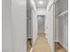Hallway with wood floors and mirrored closet doors that lead to bathroom at 4800 Grey Wolf Ln # 202, Las Vegas, NV 89149