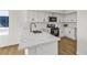 Bright kitchen with new white cabinets, stainless steel appliances and marble countertops at 4800 Grey Wolf Ln # 202, Las Vegas, NV 89149