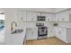 Modern kitchen featuring bright white cabinets, stainless steel appliances and marble countertops at 4800 Grey Wolf Ln # 202, Las Vegas, NV 89149