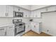 Updated kitchen with stainless appliances, white cabinetry, and modern design at 4800 Grey Wolf Ln # 202, Las Vegas, NV 89149