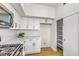 Bright kitchen with white cabinets, stainless steel microwave, and sliding door pantry at 4800 Grey Wolf Ln # 202, Las Vegas, NV 89149