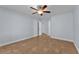 A standard bedroom with tile flooring, ceiling fan, base trim, and two entry doors at 503 Credence Ave, Henderson, NV 89002