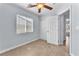 This bedroom includes a ceiling fan, closet, and a window at 503 Credence Ave, Henderson, NV 89002