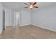 This bedroom features tile floors, neutral colored walls, and a ceiling fan at 503 Credence Ave, Henderson, NV 89002