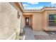 Close up of a home's front door with side window, concrete walkway and gravel landscaping at 503 Credence Ave, Henderson, NV 89002