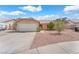 A home with a two-car garage, tile roof, gravel yard, and covered front entry at 503 Credence Ave, Henderson, NV 89002