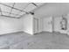 Spacious attached garage with concrete flooring, white walls, and an automatic door at 503 Credence Ave, Henderson, NV 89002