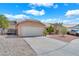 Shot of a two-car garage with adjacent gate, gravel yard, and concrete driveway in front at 503 Credence Ave, Henderson, NV 89002