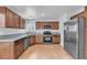Updated kitchen with stainless steel appliances, granite countertops, and wood cabinets at 503 Credence Ave, Henderson, NV 89002